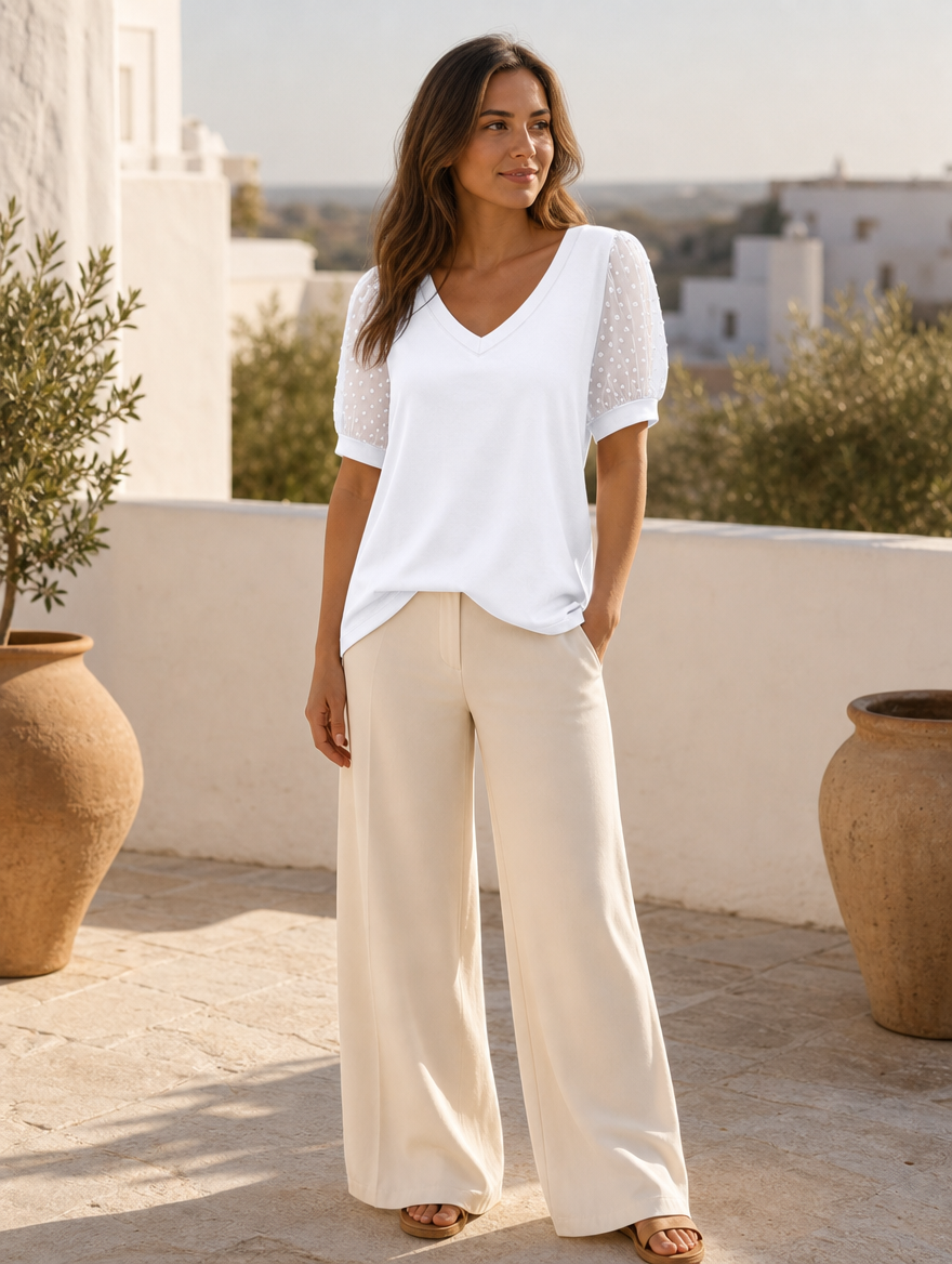 Sleek V-neck blouse worn on a sunlit Mediterranean terrace