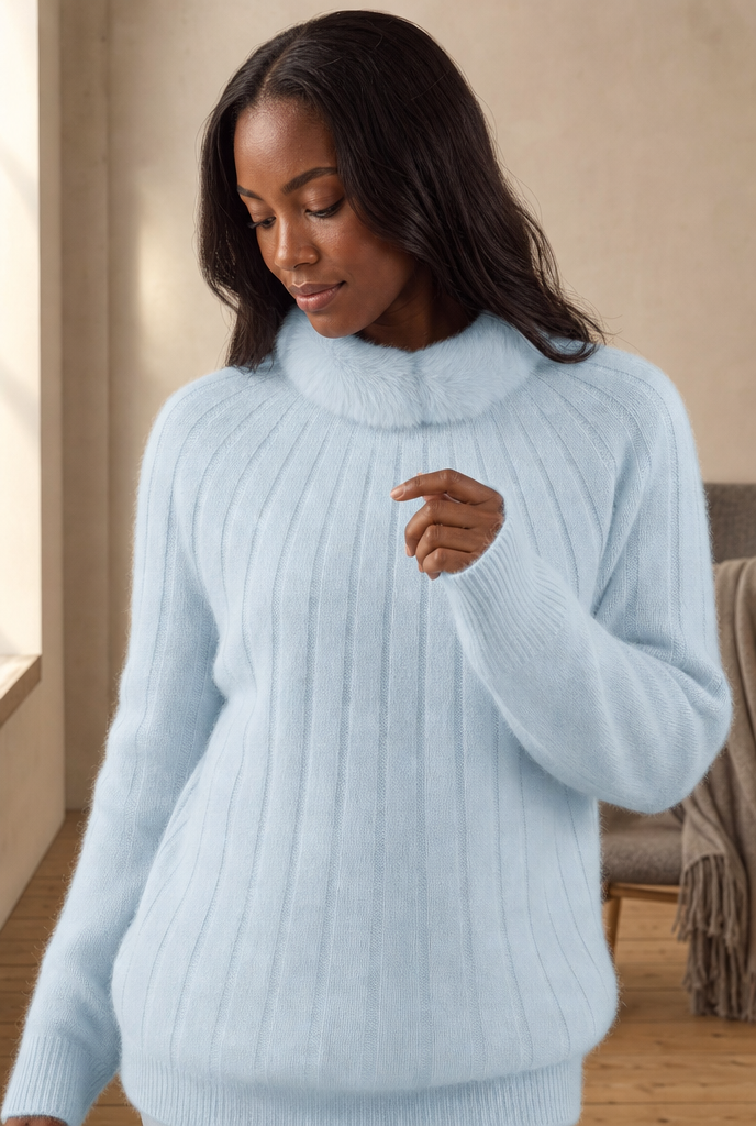 Woman in a ribbed crewneck sweater with faux fur collar in a warm interior