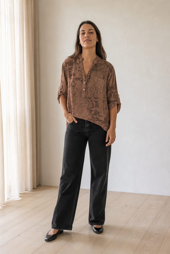 Relaxed sequin top worn in a bright minimal interior